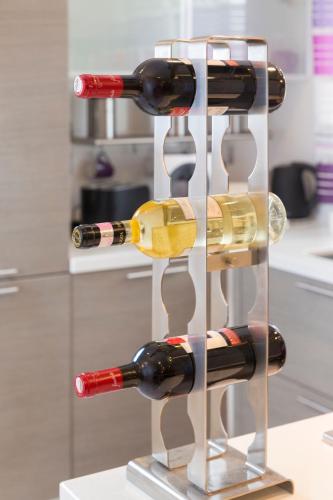 a display of wine bottles in a glass case at Sea View 2 Bed Apartment close to beach Hpi6768 in Il-Maħsel