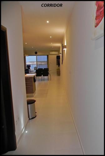 a corridor in a building with a view of the ocean at Sea View 2 Bed Apartment close to beach Hpi6768 in Il-Maħsel