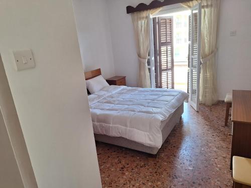 a bedroom with a bed and an open door at Big house in center of protaras, near beach in Protaras