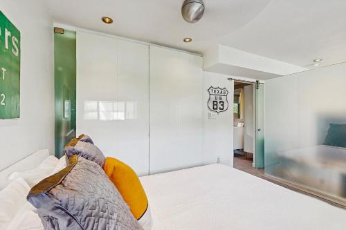 a bedroom with a bed and a large mirror at Sordid Lives Condo Permit# 3202 in Palm Springs