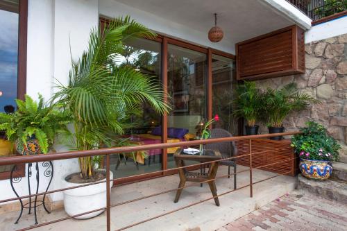 a balcony with plants and a table and chairs at Vallarta Shores Beach Hotel in Puerto Vallarta