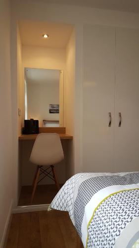 a bedroom with a bed and a desk with a chair at Tighnabruaich Annex in Lossiemouth