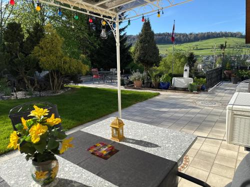 a table with a vase of flowers on a patio at Chlösterli in Luzern