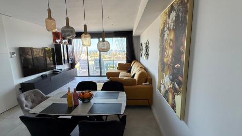 a living room with a table and a couch at SUNNY home in Finestrat