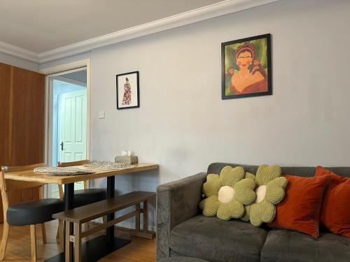 a living room with a couch and a table at Private Main Door Lovely 2 bedroom apartment in Edinburgh