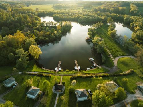 an aerial view of a lake with houses and trees at Domaine Saône-Valley in Traves