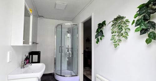 a bathroom with a glass shower and a sink at 3BR Home Near Lake Vänern - Covered Deck & BBQ in Otterbäcken