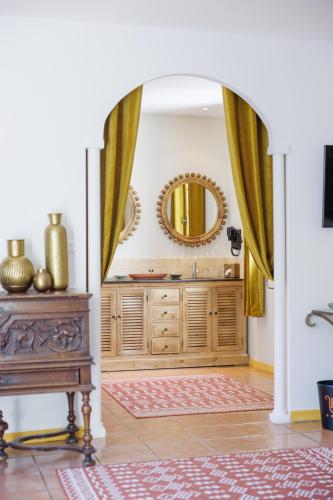 a bathroom with a mirror and a wooden dresser at Hôtel La Villa Sainte Valérie Adults Only in Juan-les-Pins
