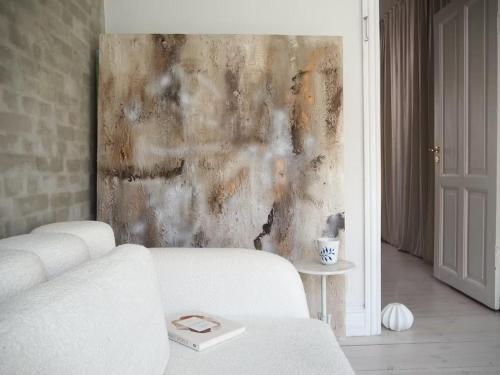 a living room with a white couch and a wall at Artsy & Bright - Scandinavian Apartment in Copenhagen