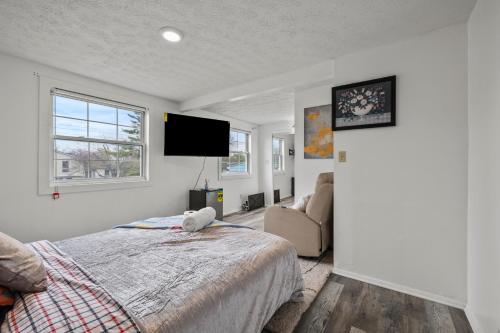 a bedroom with a bed and a flat screen tv at Cosy house, home away from home in Grove City