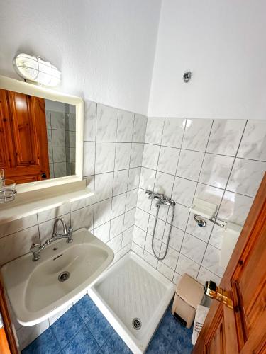a bathroom with a sink and a mirror at Studios Melida in Skala Potamias