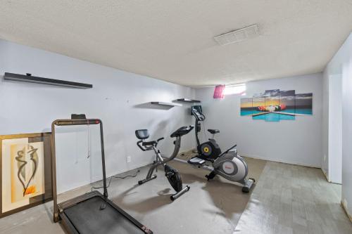 a gym with two exercise bikes in a room at Cosy house, home away from home in Grove City
