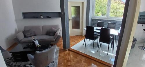 a living room with a table and a couch at Lena Exclusive in Bihać