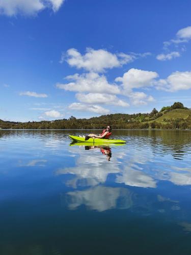 a person in a yellow kayak on a lake at Tinyhouse Pichi I - vida lenta en Patagonia Costa in Calbuco
