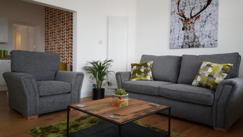 a living room with two couches and a coffee table at Tighnabruaich Annex in Lossiemouth