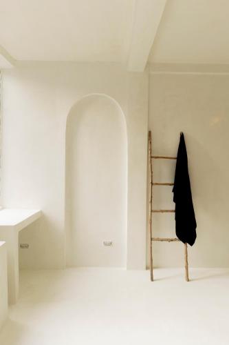 a room with a ladder and a white wall at The Hidden Home in Patong Beach