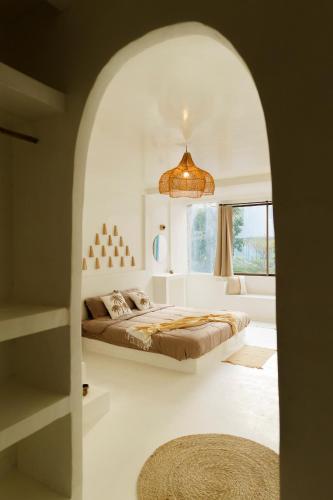 a bedroom with a bed and a large window at The Hidden Home in Patong Beach