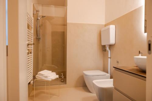 a bathroom with a shower and a toilet and a sink at Tormini Scalo in Roe