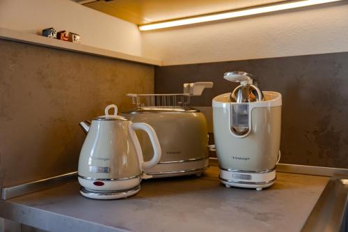 three appliances sitting on a counter in a kitchen at Tormini Scalo in Roe