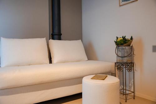 a living room with a couch and a stool at Tormini Scalo in Roe