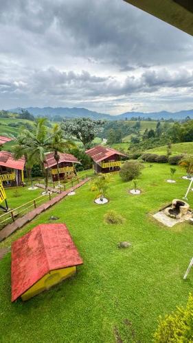 an aerial view of a resort with a green field at MO Cabaña Nido de Colibrí a pocos minutos de los termales de Santa Rosa de Cabal in Santa Rosa de Cabal