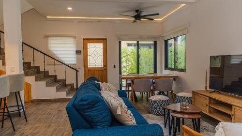 a living room with a blue couch and a table at Casa Azul in Cruz de Huanacaxtle