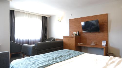 Ένα ή περισσότερα κρεβάτια σε δωμάτιο στο Varyant Hotel
