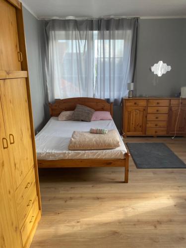 a bedroom with a bed with a large window at Monika House in Warsaw