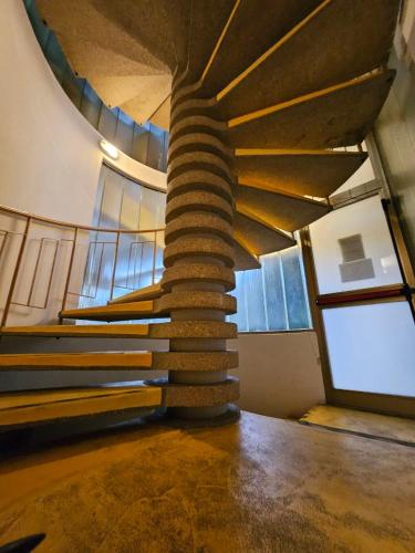 a spiral staircase in a building with windows at Albergo Nyers in Perugia