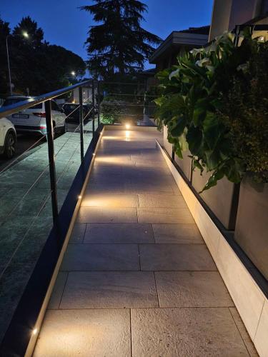 a walkway with lights on the side of a building at Albergo Nyers in Perugia