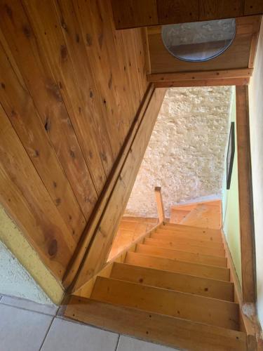 a wooden staircase in a room with a wooden ceiling at Gite Sainte Croix in Monestier