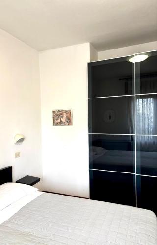 a bedroom with a bed and a glass wall at APPARTAMENTO -B- VISTA MARE con 2 camere da letto-Residence Azzurro in Gabicce Mare