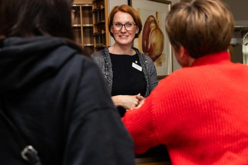 a woman standing in a group of people at Ringhotel Appelbaum Gütersloh in Gütersloh