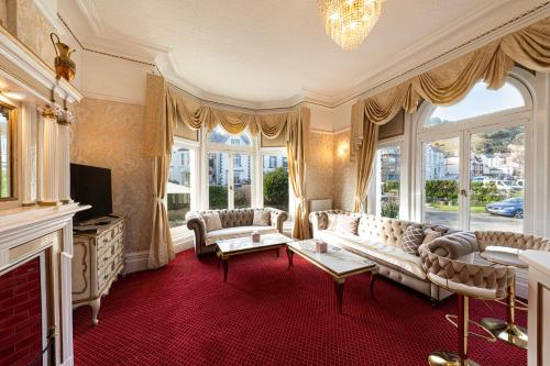 a living room with a couch and a fireplace at The Annan Hotel in Llandudno