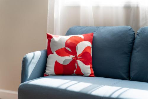 a blue chair with a red and white pillow on it at Fabulous 3bdrm Home With Parking in Highland Falls