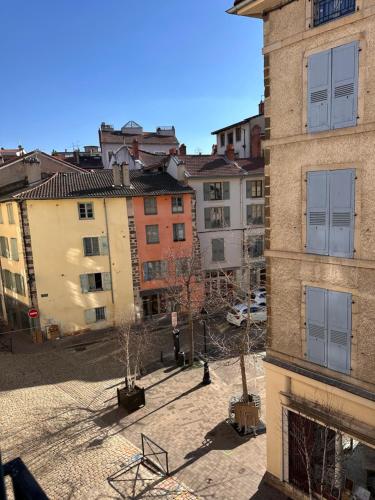 a view of a courtyard in a city with buildings at le paradis blànc in Le Puy en Velay