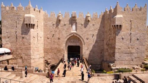 a group of people walking into a castle at New Metropole Hotel - Jerusalem in Jerusalem