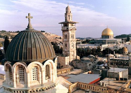 an old building with a cross on top of it at New Metropole Hotel - Jerusalem in Jerusalem