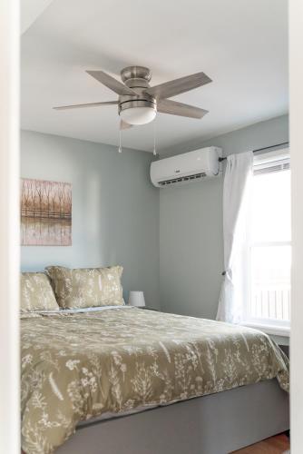 a bedroom with a bed with a ceiling fan at Fabulous 3bdrm Home With Parking in Highland Falls