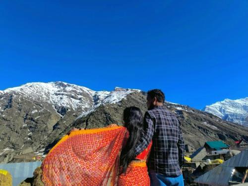 a man and a woman looking at the mountains at Rupi Rani Home Stay in Gushāl