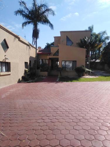 a brick driveway in front of a house at Zenith Guesthouse in Pretoria