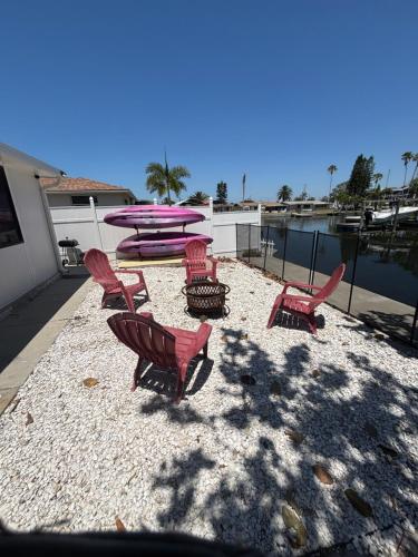a group of chairs and surfboards on a beach at Gorgeous Seaside Seashell Cottage! in Hudson
