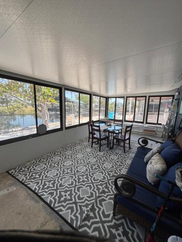 a room with a couch and a table in a building at Gorgeous Seaside Seashell Cottage! in Hudson