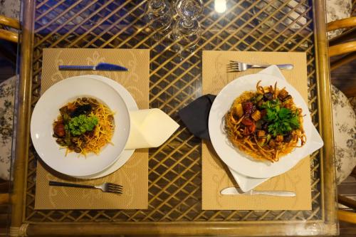 a tray with two plates of food on a table at Çınar Butik Hotel Bodrum in Bodrum City
