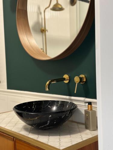 bagno con lavabo nero e specchio di Przedmiejska2 Apartment a Breslavia