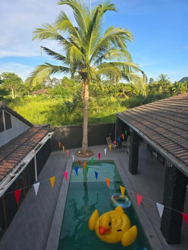a pool with a toy elephant in the middle of a house at ForestPoolvilla in Na Jomtien