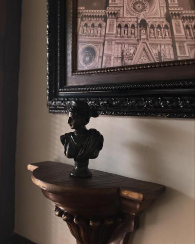 a statue sitting on a table in front of a picture at Casa Rural con encanto Señorio Manchego ALBACETE in Yeste