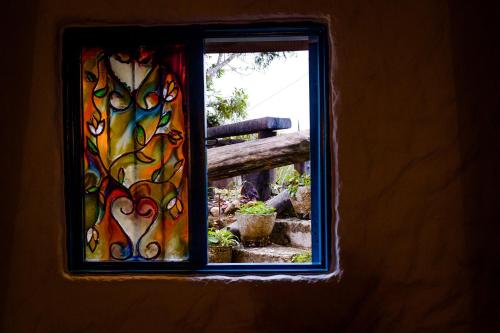 a window with a view of a fence at Casa Encuentro Ecolodge, Outdoor Gym and Yoga in Guatapé