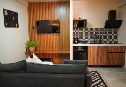 a living room with a couch and a kitchen at Bacaanda #2 in Oaxaca City