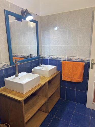 a bathroom with two sinks and a mirror at Havre De Paix in Somone